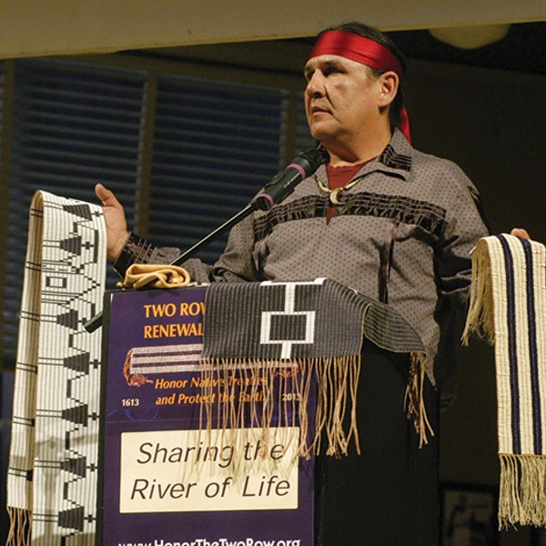 Jake Edwards of the Onondaga Nation Council of Chiefs holding the Canandaigua Treaty Belt and the Two Row Wampum Belt at event in January in Syracuse.