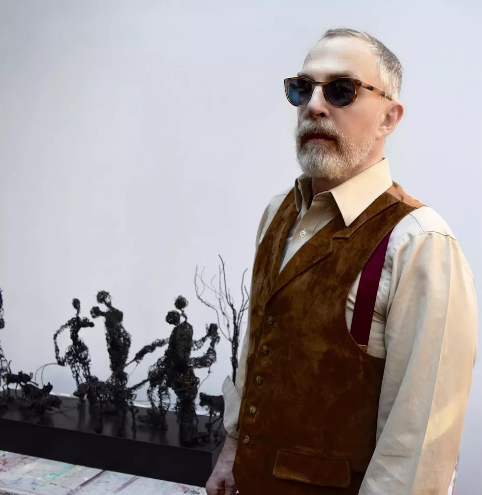 Busser Howell with his Sidewalk Saga Sculptures