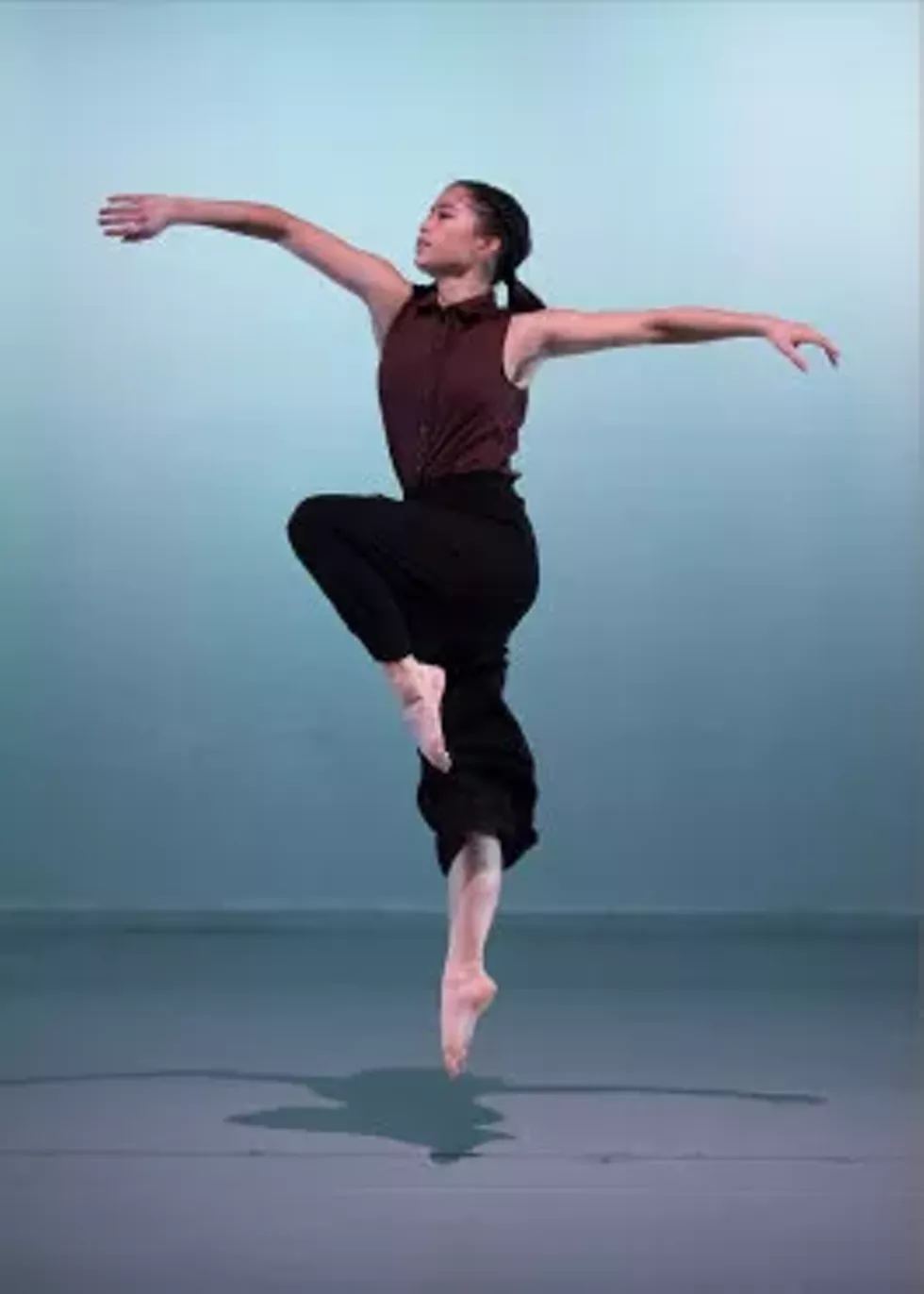 Kathryn Taylor joyfully jumping with open arms
