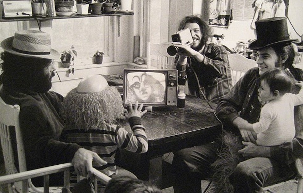 Videofreex (l. to r.) David Cort, Bart Friedman, and Parry Teasdale (holding Sarah Teasdale) introduce Lanesville, NY resident Scottie Benjamin to Sony Portapak technology at Maple Tree Farm, 1973