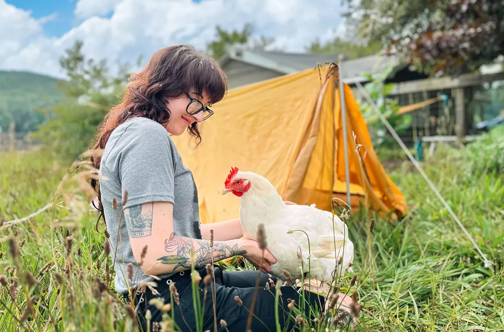 Woodstock Staff Member with Dot the Rescued Chicken