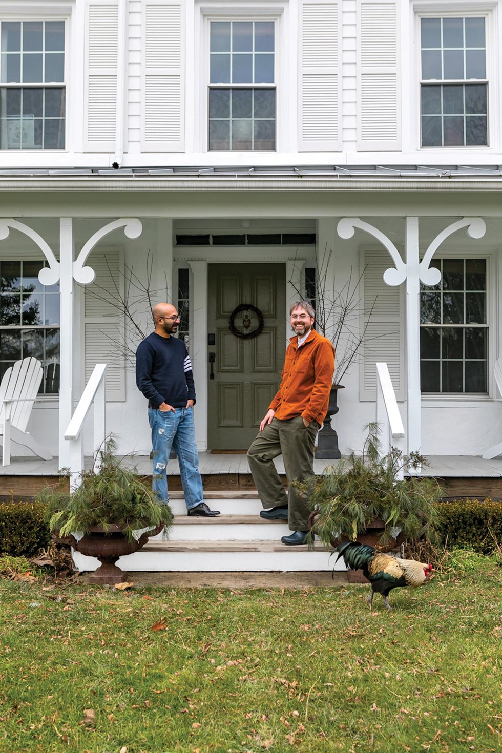 David Krause and Ayan Chatterjee on the front porch of their 1850 Colonial-style farmhouse in the Greene County hamlet of Freehold.