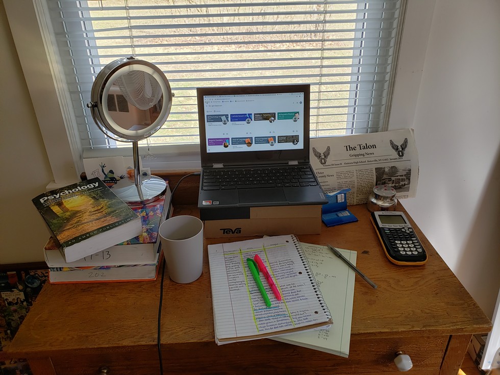 The author&#146;s online school setup. The computer is on a shoebox and the makeup mirror is for light when on camera.