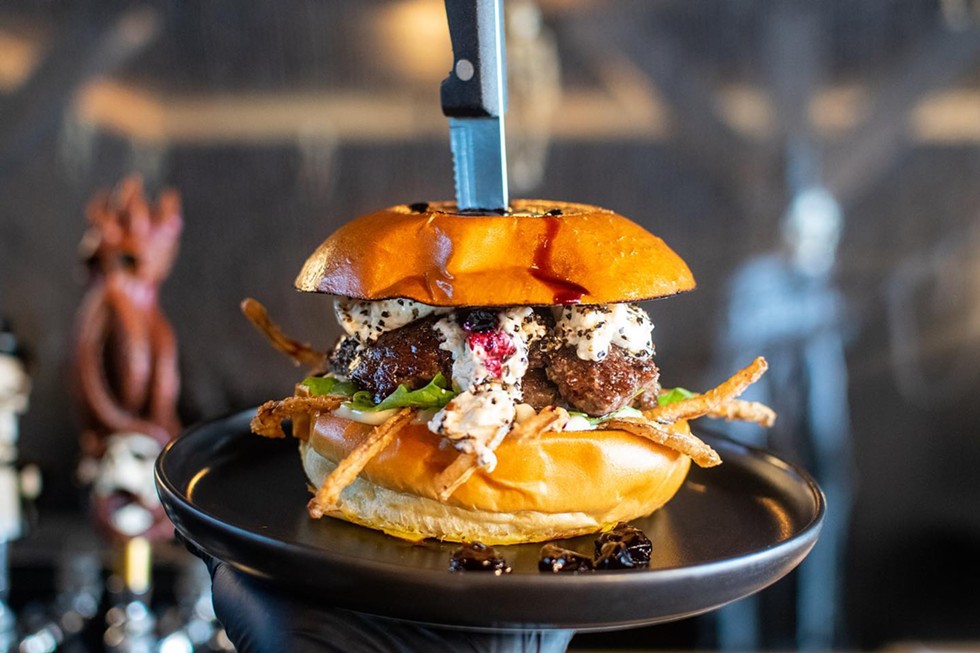 October 2022's wildly popular burger of the month: Nightmare on Main Street, featuring black peppered goat cheese, red wine cherry reduction, crispy house fried onions, garlic aioli and arugula.