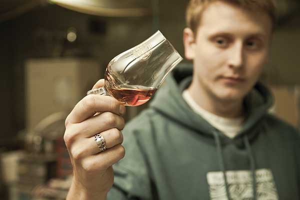 Tuthilltown Spirits packaging manager Brendan O’Rourke taste testing Hudson Whiskey.
