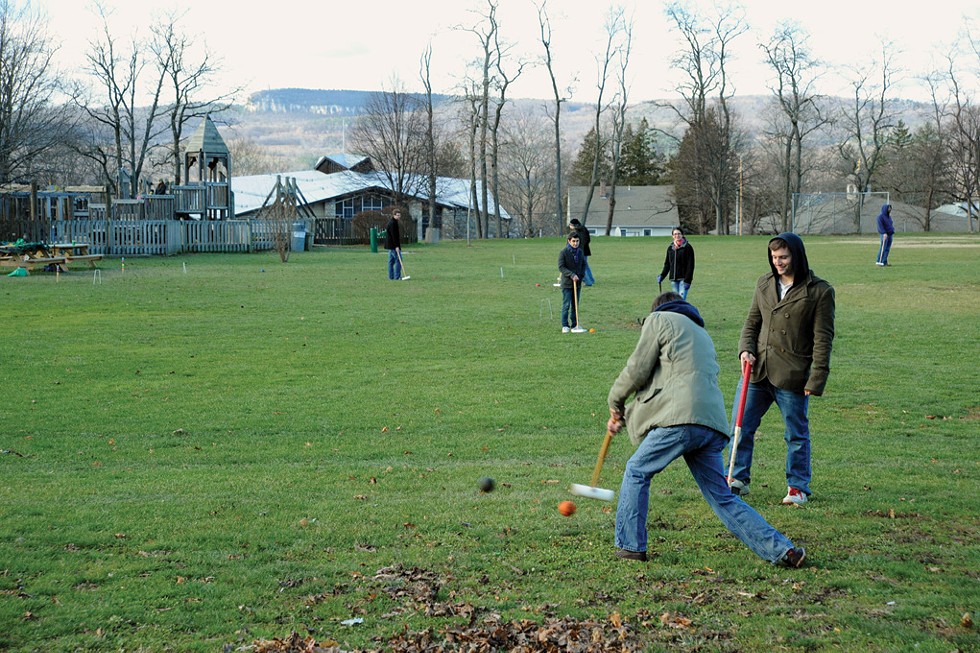 Students playing croquet in Hasbrouck Park, across from the SUNY New Paltz campus, with the Shawangunk Ridge in the background.